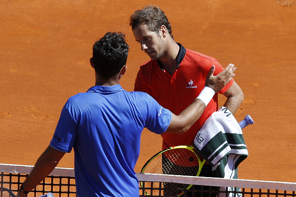 Nicolas Almagro congratulates Richard Gasquet at the net (Photo:Valery Hache/Getty Images)