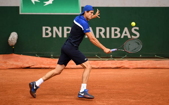 Guillermo Garcia-Lopez of Spain plays a backhand against Dominic Thiem at Roland Garros. (Photo by Dennis Grombkowski/Getty Images)