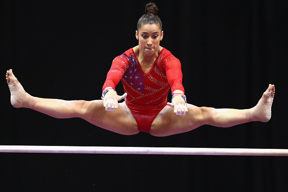 Aly Raisman doing a release move on the uneven bars at the Secret US Classic in Hartford/Getty Images