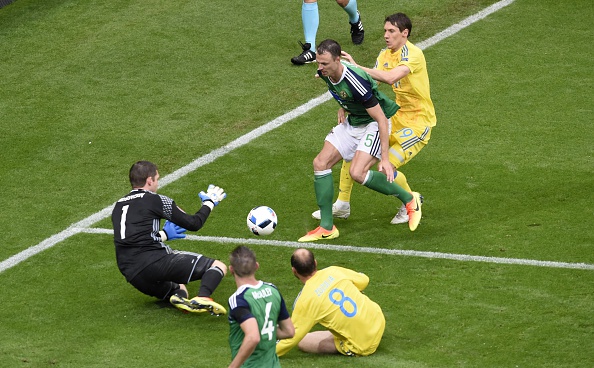 Northern Ireland's goalkeeper Michael McGovern dives for the ball during the Euro 2016 group C football match between Ukraine and Northern Ireland at the Parc Olympique Lyonnais stadium in Décines-Charpieu near Lyon on June 16, 2016. / AFP / JEAN-PHILIPPE KSIAZEK (Photo credit should read JEAN-PHILIPPE KSIAZEK/AFP/Getty Images)