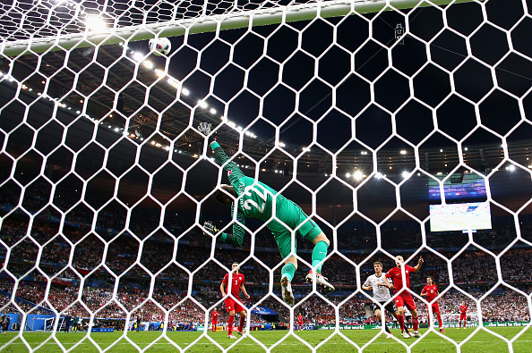 Lukasz Fabianski makes a flying save as he preserves his clean sheet against Germany. (Photo: Paul Gilham/Getty Images)