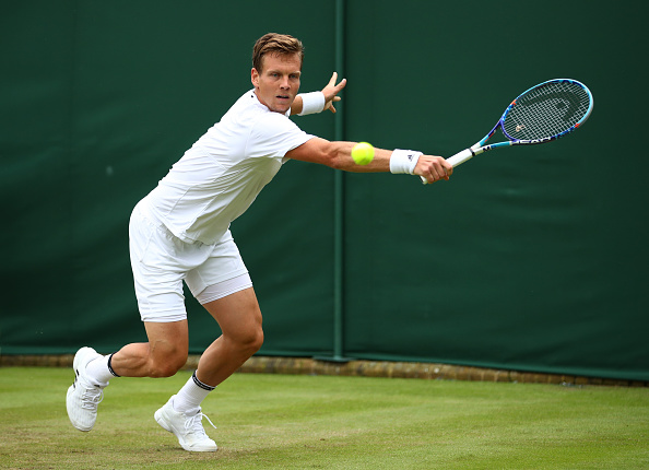 Tomas Berdych returns a serve against Ivan Dodig at Wimbledon/Getty Images