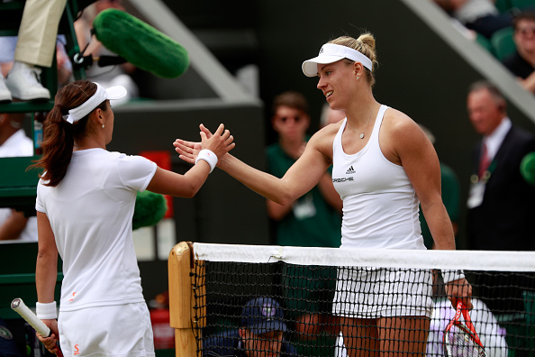 Doi (left) and Kerber (right) shake hands at the net after the conclusion of their match. Photo credit: Adam Pretty/Getty Images.