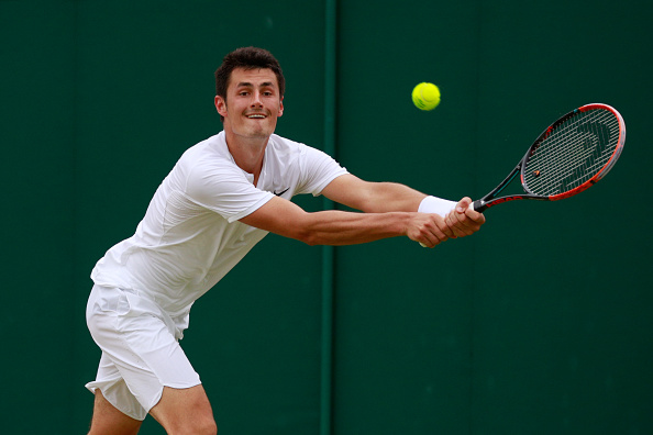 Tomic reaches for a backhand/Photo: Adam Pretty/Getty Images