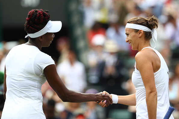 Venus Williams (L) celebrates victory during her quarterfinal match against Yaroslava Shvedova (R) at the Wimbledon Lawn Tennis Championships. (Photo by Julian Finney/Getty Images)