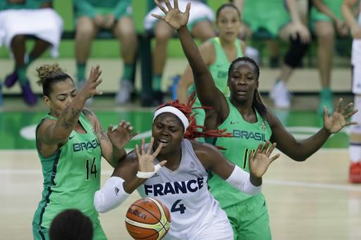 France forward Isabelle Yacoubou is surrounded by two Brazil defenders while trying to recover the ball during the team's group stage game in Rio/Photo: Carlos Osorio/AP