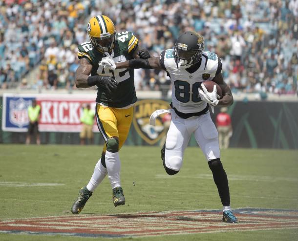 Allen Hurns holds off a challenge during the game (Photo: Mike Ehrmann/ Getty Images)