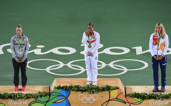 ​ Silver medallist Angelique Kerber (left), gold medallist Puig and bronze medallist Petra Kvitova (right) on the podium after receiving their medals. Photo credit: Luis Acosta/Getty Images.Silver medallist Angelique Kerber (left), gold medallist Puig and bronze medallist Petra Kvitova (right) on the podium after receiving their medals. Photo credit: Luis Acosta/Getty Images.Click and drag to move ​