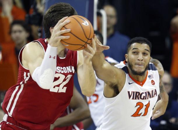 Happ tries to drive on Virginia's Isaiah Wilkins during the team's game in Charlottesville/Photo: Steve Helber/Associated Press