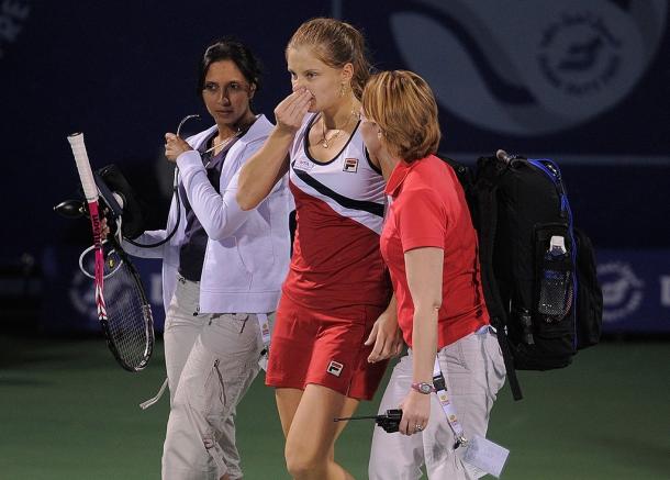 Chakvetadze being helped by tournament officials after collapsing on court at the Dubai Tennis Championships in 2011. Photo: 