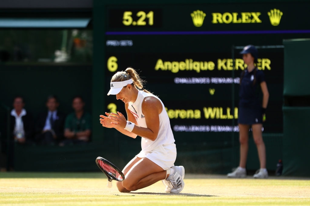 Kerber drops to the grass turf in celebration upon converting championship point in the 2018 Wimbledon final. Photo: Michael Steele