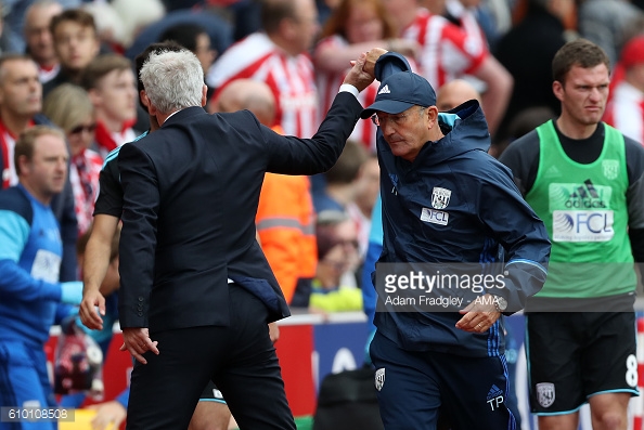 Awkward: Hughes and Pulis endure uncomfortable handshake as Baggies snatch late point (photo:getty)