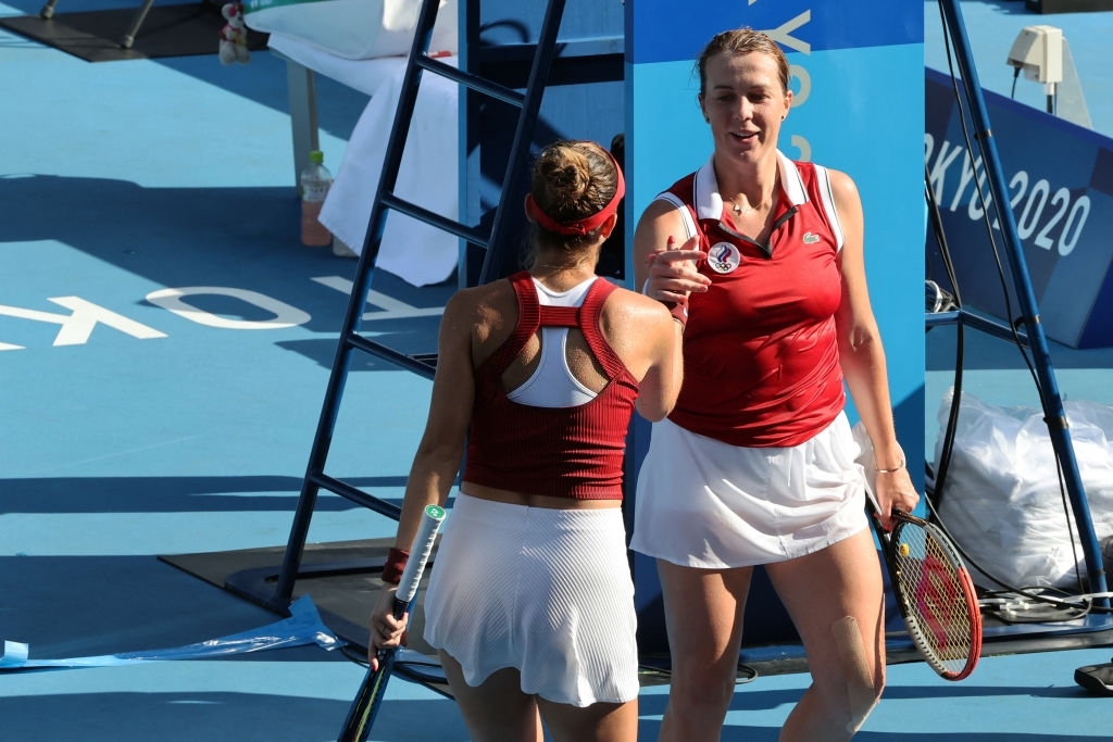 Both athletes share a handshake after the conclusion of their quarterfinal encounter. Photo: 