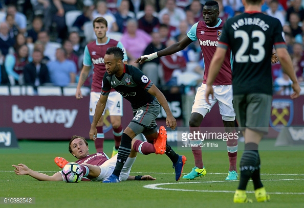Above: West Ham United skipper Mark Noble sliding in on Nathan Redmond in their 3-0 defeat to Southampton | Photo: Getty Images