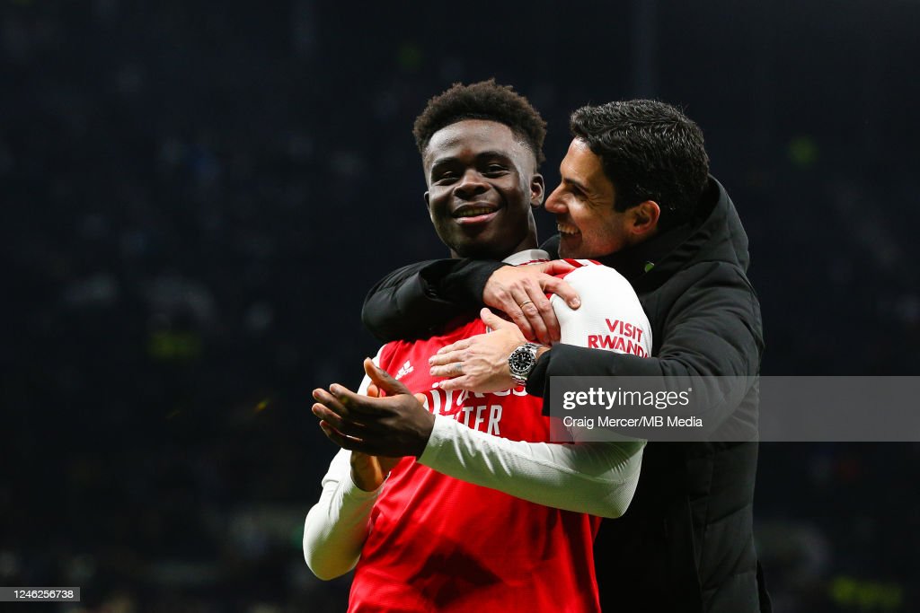 Arsenal manager Mikel Arteta celebrates with Bukayo Saka of Arsenal after the Premier League match between Tottenham Hotspur and Arsenal FC at Tottenham Hotspur Stadium on January 15, 2023 in London, United Kingdom. (Photo by Craig Mercer/MB Media/Getty Images)