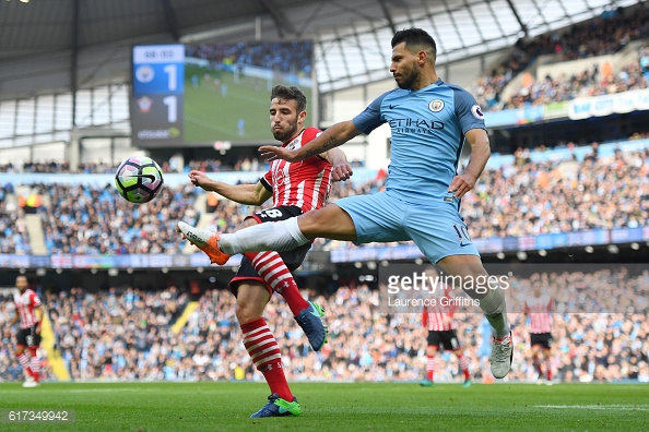 Sergio Aguero beats Sam McQueen to the ball in the first half | Photo: Getty images / Laurence Griffiths