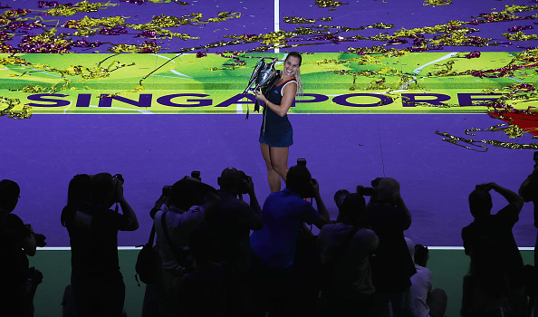 Cibulkova graces the court with her trophy in front of photographers after the conclusion of the final. Photo credit: Julian Finney/Getty Images.