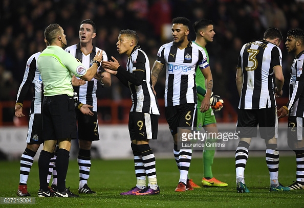 Newcastle players protest after going down to nine men. (picture: Getty Images / Laurence Griffiths)