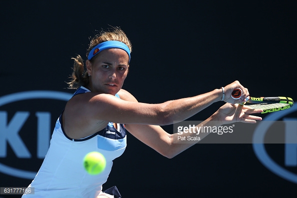 Monica Puig lunges for a backhand return during her first round match at the 2017 Australian Open/Photo: Pat Scala/Getty Images
