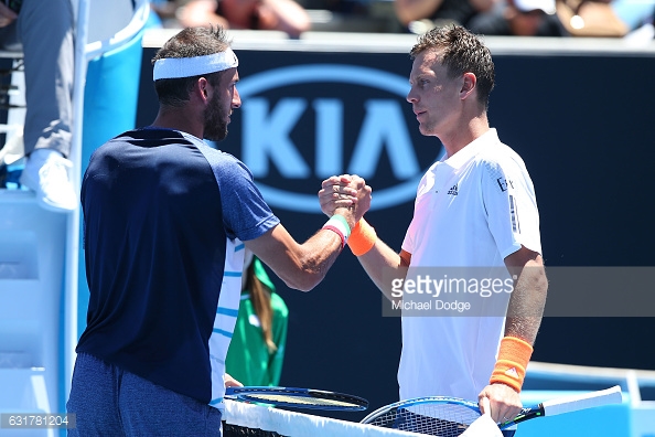 Berdych and Vanni meet at the net following the Italian's retirement from their first round match in Melbourne/Photo: Michael Dodge/Getty Images