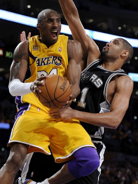 Kobe Bryant snatches the rebound away from Tim Duncan