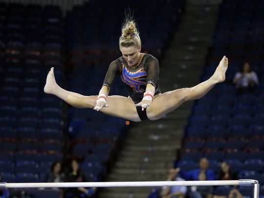 Bridget Sloan performs on the uneven bars at the NCAA Women's Gymnastics Championships/AP