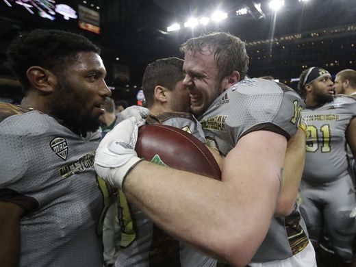 Western Michigan linebacker Robert Spillane (r.) is congratulated by his teammates after intercepting Ohio on the final drive of the game/Photo: Carlos Osorio/Associated Press