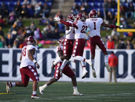 Temple Owls defensive back Nate Hairston (15) celebrates defensive back Delvon Randall (23) and wide receiver Ventell Bryant (1) after intercepting Navy backup quarterback Zach Abey. Photo: Tommy Gilligan/USA Today Sports