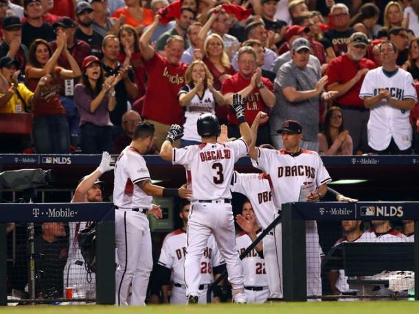 Daniel Descalso (3) is greeted by manager Tory Lovullo (17) after hitting a home run in the fifth inning. |Source – Mark Rebilas/USA TODAY Sports|