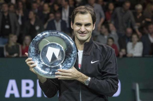 Roger Federer hoists the trophy in Rotterdam, capping off a dream week. Photo: Patrick Post/AP