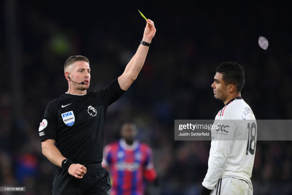 Referee Robert Jones gives a yellow card to Casemiro of Manchester United during the Premier League match between Crystal Palace and Manchester United at Selhurst Park on January 18, 2023 in London, England. (Photo by Justin Setterfield/Getty Images)