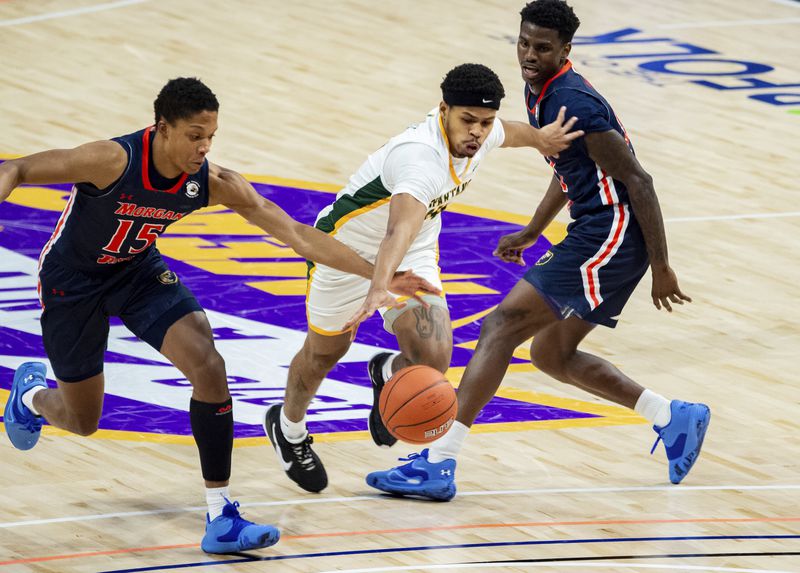 Norfolk State's Devante Carter tries to drive between two Morgan State defenders during the MEAC Championship game/Photo: Mike Caudill/Associated Press