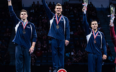 Sam Mikulak, Chris Brooks, and Jake Dalton on the podium at the P&G Men's Gymnastics Championships in Hartford/Getty Images
