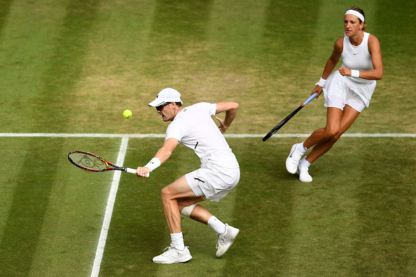Jamie Murray plays a return with Victoria Azarenka looking on (Photo: Clive Mason/Getty Images)