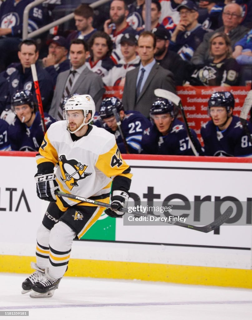 Adam Johnson #47 of the Pittsburgh Penguins keeps an eye on the play during third period action against the Winnipeg Jets at the Bell MTS Place on October 13, 2019 in Winnipeg, Manitoba, Canada. The Pens defeated the Jets 7-2. (Photo by Darcy Finley/NHLI via Getty Images)