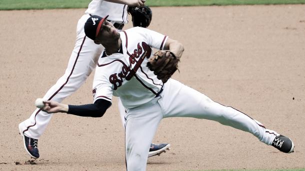 Andrelton Simmons aims for first base while turning two. (David Tulis/AP)