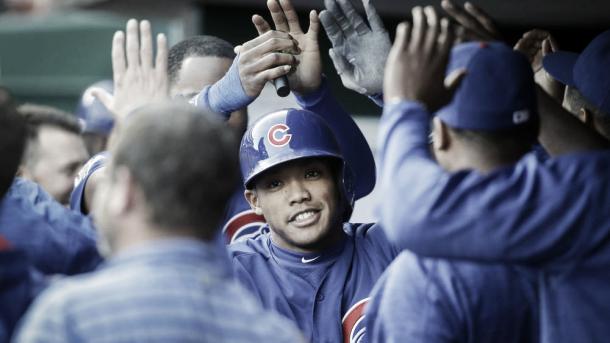 Addison Russel high fives teammates after his home run in the second inning of Saturday nights game in Cincinnati (AP)