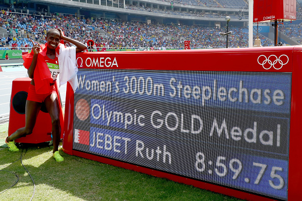 Ruth Jebet poses with the information board after taking gold in the steeplechase (Getty/Alexander Hassenstein)