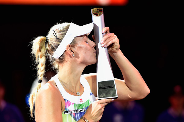 Angelique Kerber kisses the winner's trophy after winning the 2016 Porsche Tennis Grand Prix. | Photo: Dennis Grombkowski/Bongarts