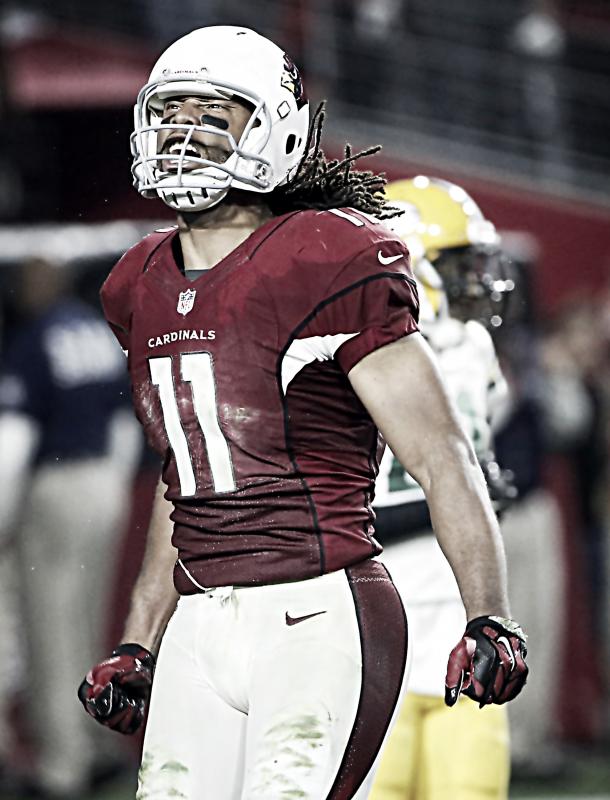 Arizona Cardinals wide receiver Larry Fitzgerald (11) celebrates his catch in the red zone to set up a game winning touchdown against the Green Bay Packers during overtime in the NFL divisional playoff football game (AP Photo/Ross D. Franklin)