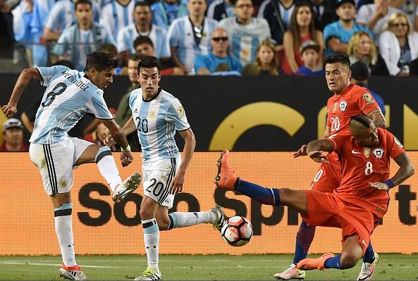 Chile midfielder Arturo Vidal (right, in red, on ground) lost his composure in Monday's loss to Argentina. Photo credit: Mark Ralston/AFP, Getty Images Sport