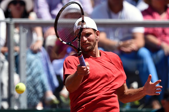 Philip Bester returns the ball to Richard Gasquet in their fourth rubber match (Photo:Miguel Medina/Getty Images) 