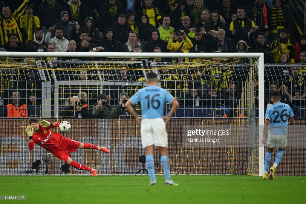 Riyad Mahrez of Manchester City has a penalty saved by Gregor Kobel of Borussia Dortmund during the UEFA Champions League group G match between Borussia Dortmund and Manchester City at Signal Iduna Park on October 25, 2022 in Dortmund, Germany. (Photo by Matthias Hangst/Getty Images)