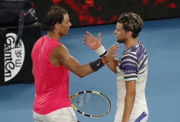 The two combatants meet at the net after their quarterfinal epic/Photo: Isae8 Katp/Reuters