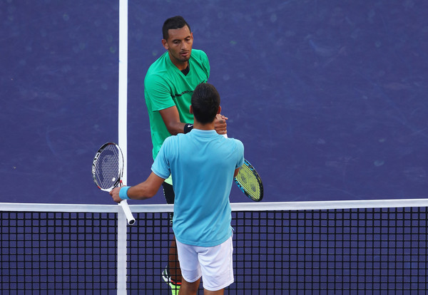 Both players meet at the net after the match | Photo: Clive Brunskill/Getty Images North America