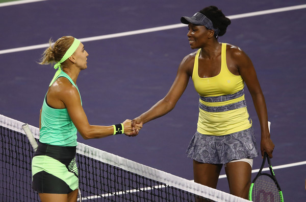 Both players meet at the net after the match | Photo: Clive Brunskill/Getty Images North America