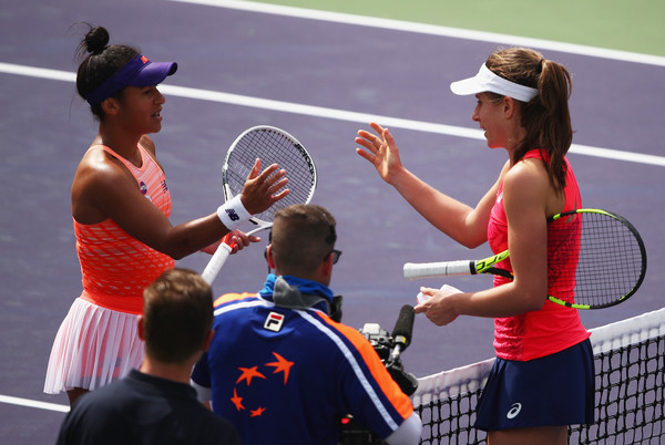 Both players meet at the net after the match | Photo: Clive Brunskill/Getty Images North America