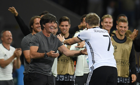 Schweinsteiger celebrates with his manager. | Image credit: PATRIK STOLLARZ/AFP/Getty Images