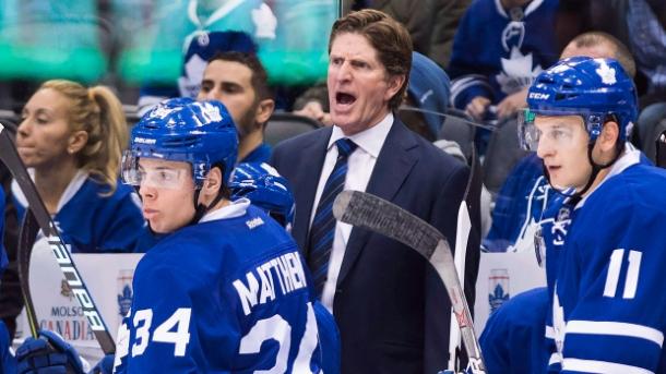 Mike Babcock (centre) shouts instructions over the heads of young stars Auston Matthews (left) and Zack Hyman (right)