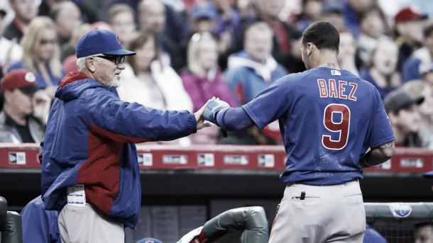 The Cubs' Javier Baez is congratulated by manager Joe Maddon after scoring on a sacrifice fly by David Ross in the second inning of the game against the Cincinnati Reds at Great American Ball Park on April 22, 2016, in Cincinnati.(Joe Robbins/Getty Images